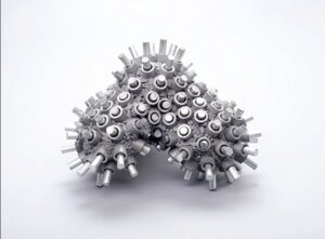 A metal sculpture with small appendages which give it the appearance of some kind of abstract sea coral