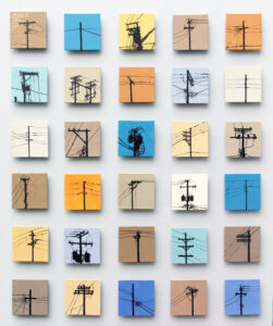 A grid of shiny, ceramic tiles on a wall, each in different pastel colors and each with a different image of an electrical pole with different arrangements of wires running through