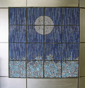 A grid of ceramic tiles depicting a sea with a full moon overhead in a various stylized manner