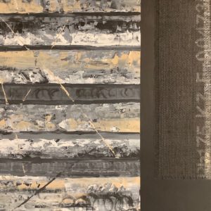 An abstract art piece close-up with white, gray and light, creamy yellow paint streaking in bands next to a rectangle of industrial burlap material with numbers and letters printed on it