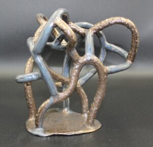 A sculpture of intertwined, metallic and stone like branches